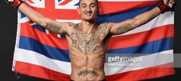 Max Holloway poses after his victory